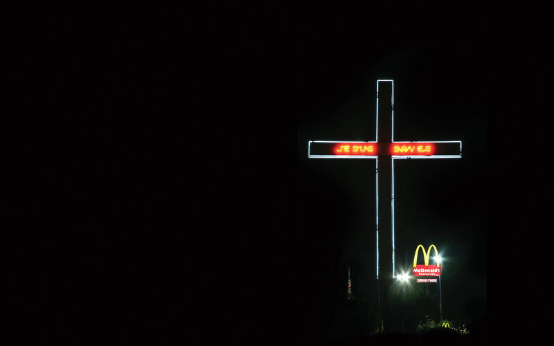 Neon cross with McDonald's sign