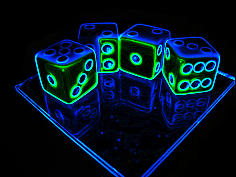 Neon dice on a dark surface
