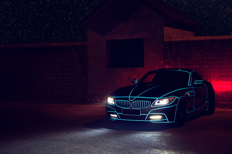 Neon-lit car at night