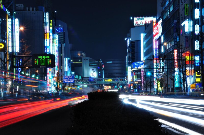 Neon-lit city street at night