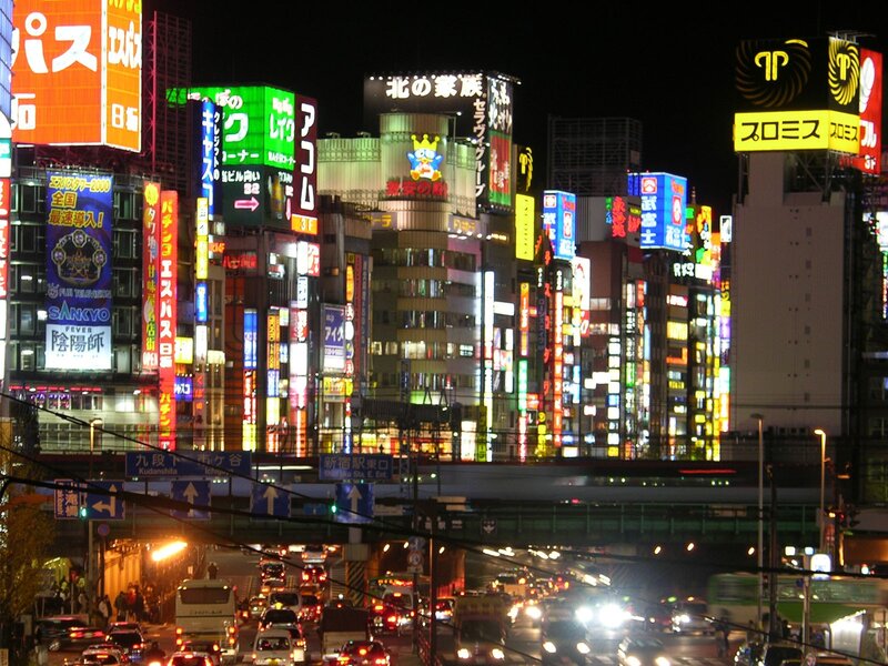 Neon-lit city street at night