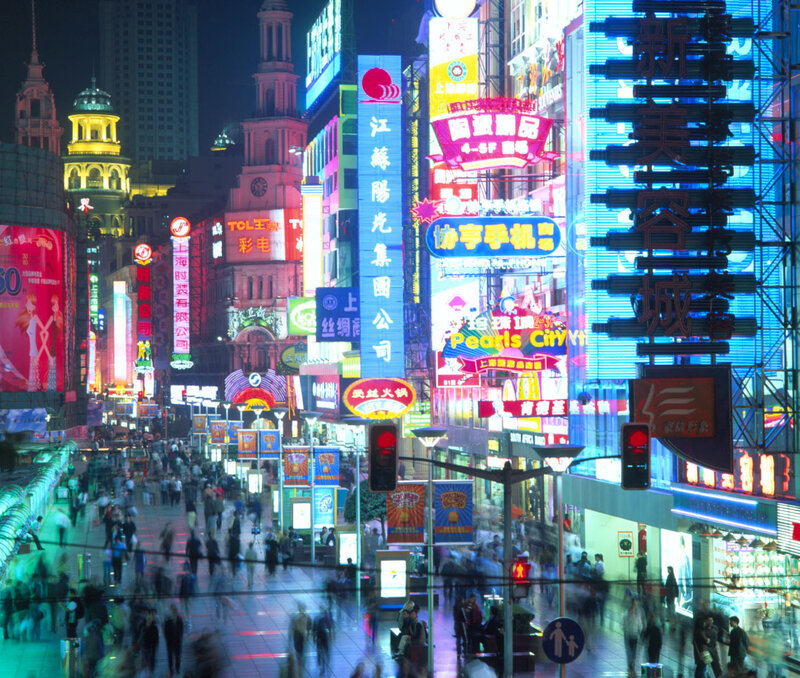 Neon-lit city street at night