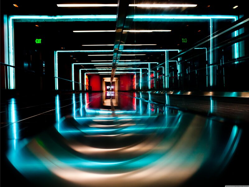 Neon-lit corridor with reflections