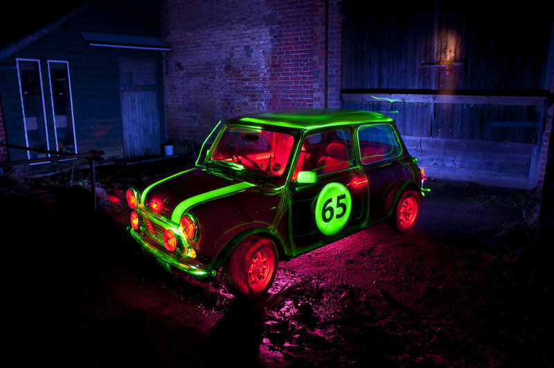 Neon-lit Mini Cooper at night