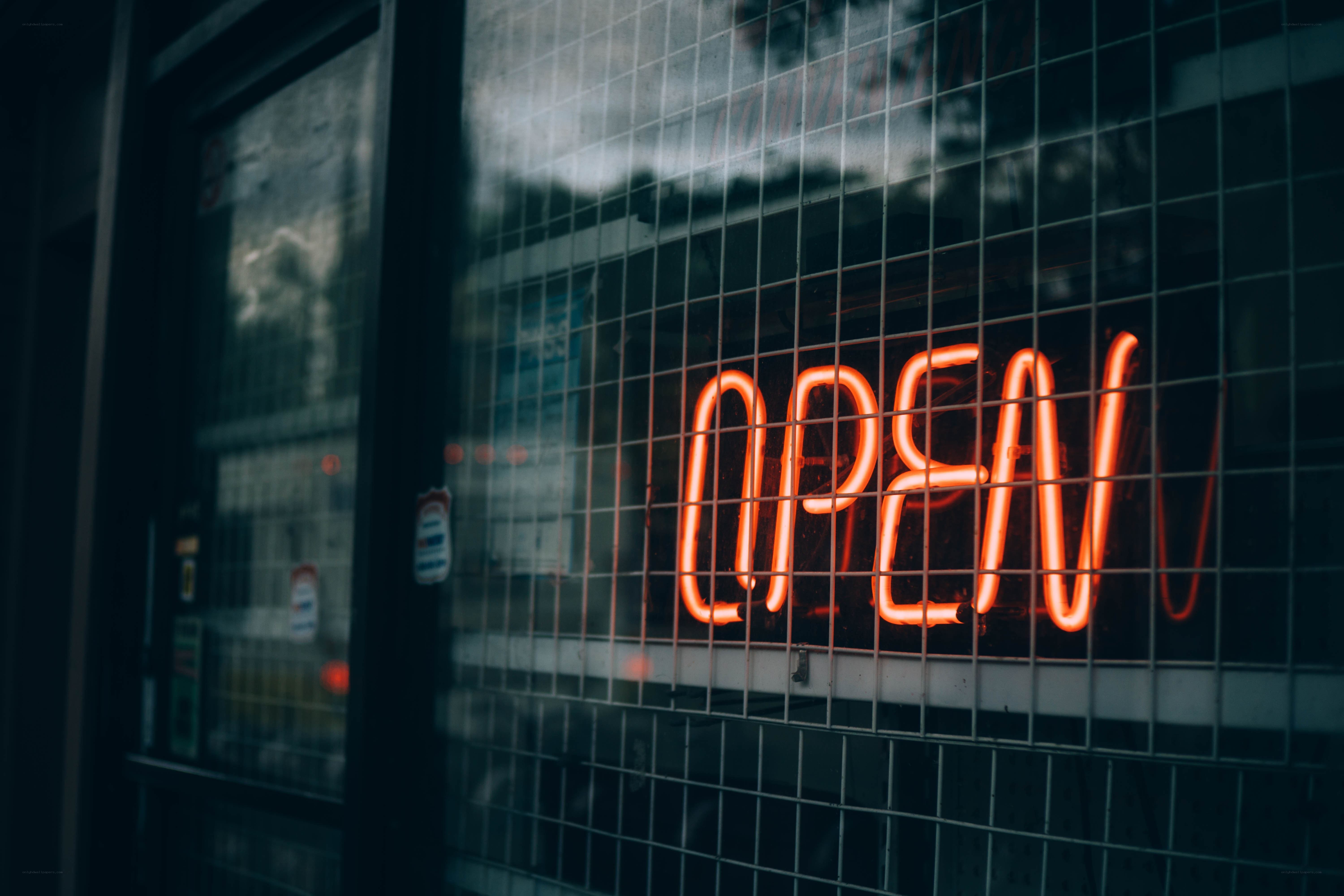 Neon open sign behind glass