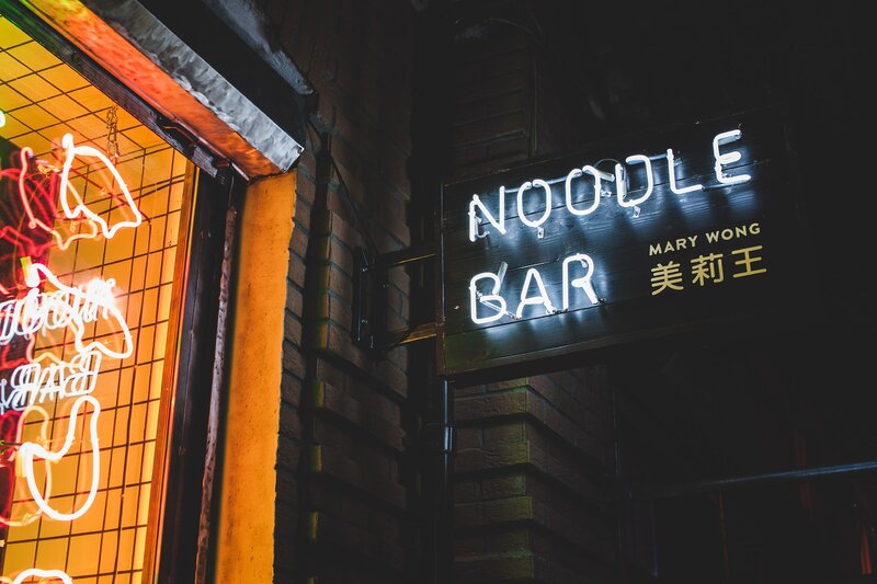 Neon Sign on Brick Wall — Black, Dramatic