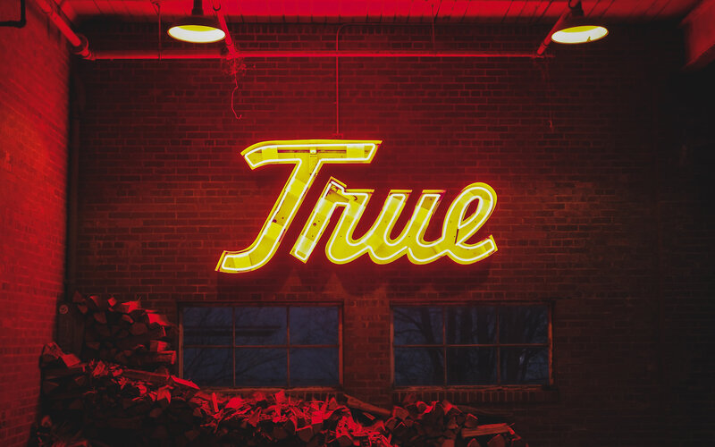 Neon Sign on Brick Wall — Red, Dramatic