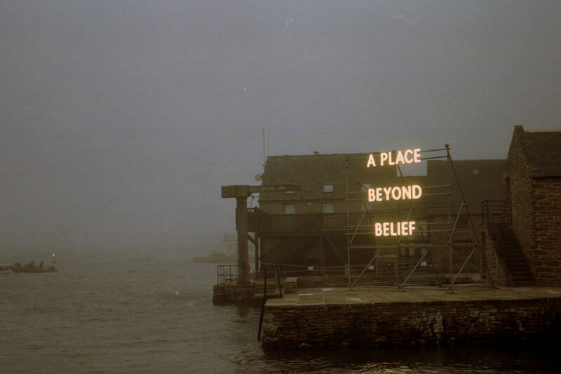 Neon Sign on Building — Gray