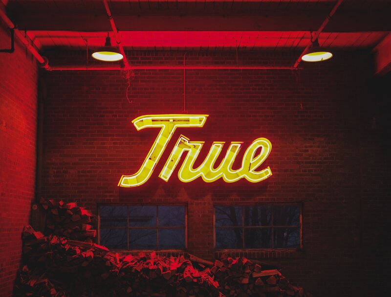 Neon sign reading 'True'