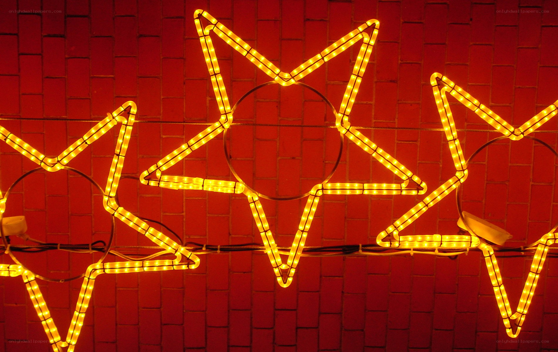 Neon star lights on brick wall