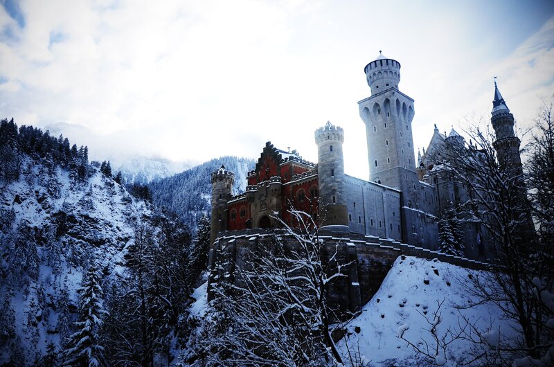 Neuschwanstein Castle — White, Dramatic, Winter, Photograph, Snow, Mountains, Trees, Gray