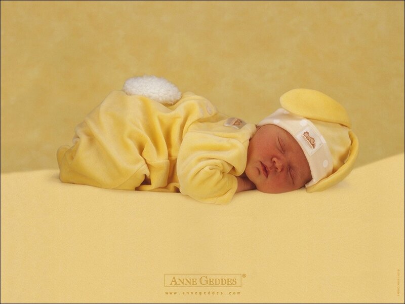 Newborn baby in yellow outfit