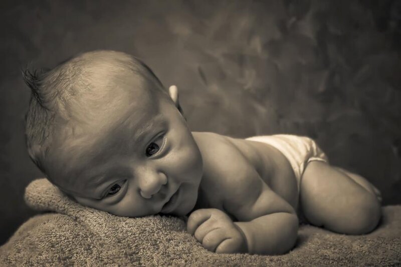 Newborn baby lying on towel