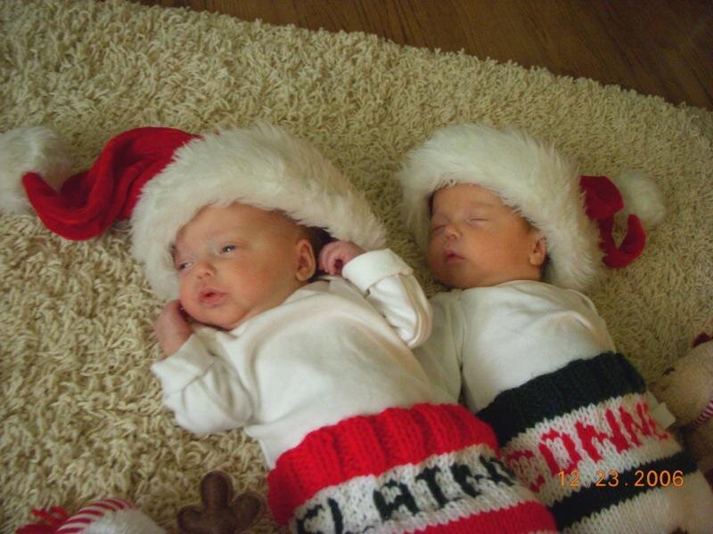 Newborn twins in Santa hats