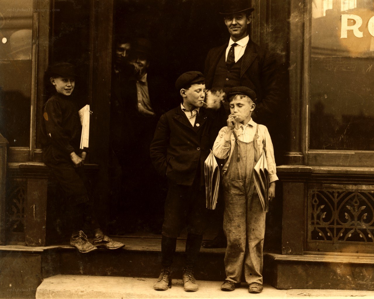 Newsboys outside a shop