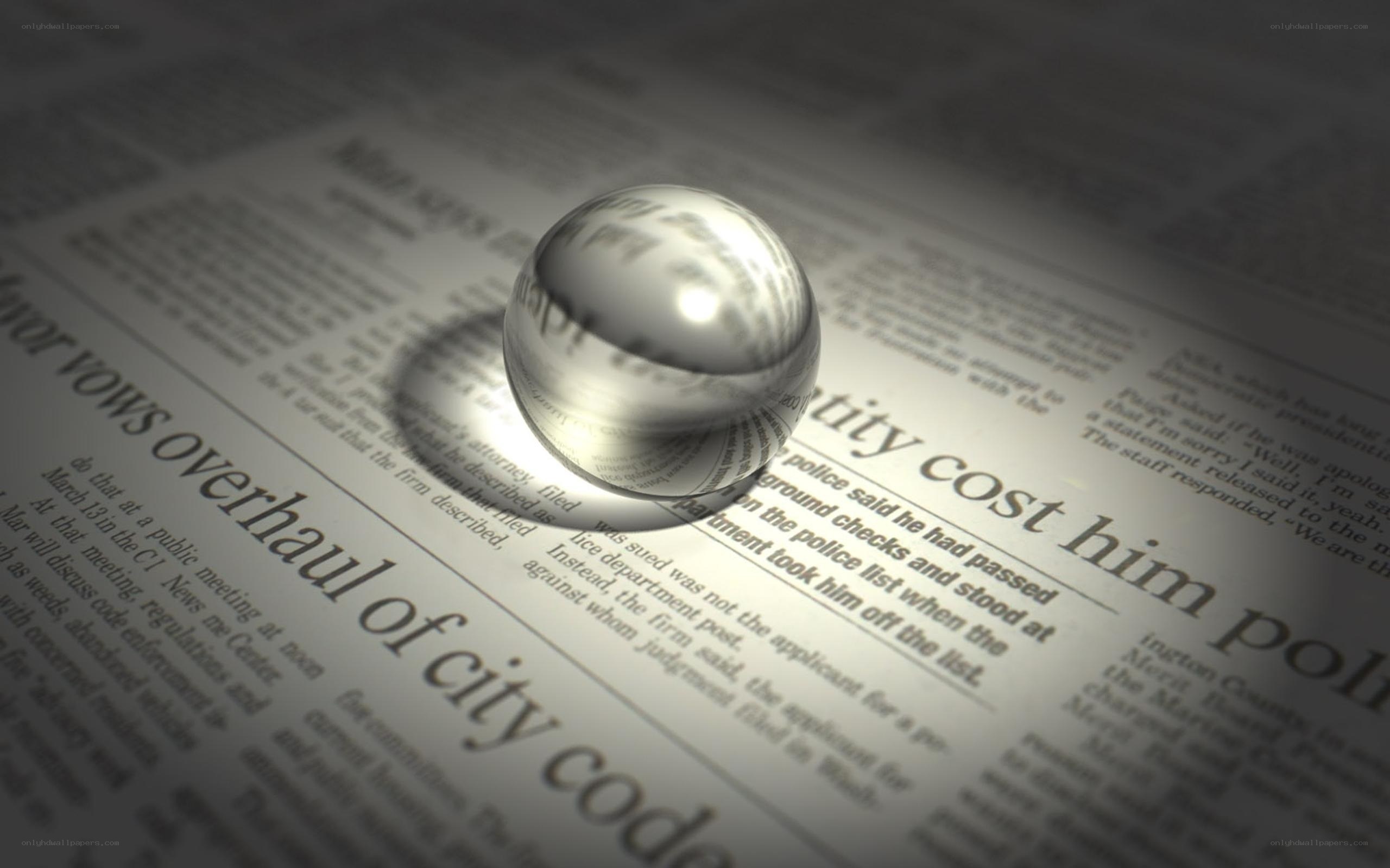 newspaper with glass sphere