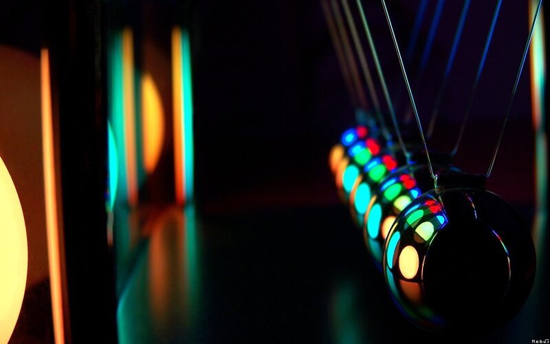 Newton's cradle with colorful lights