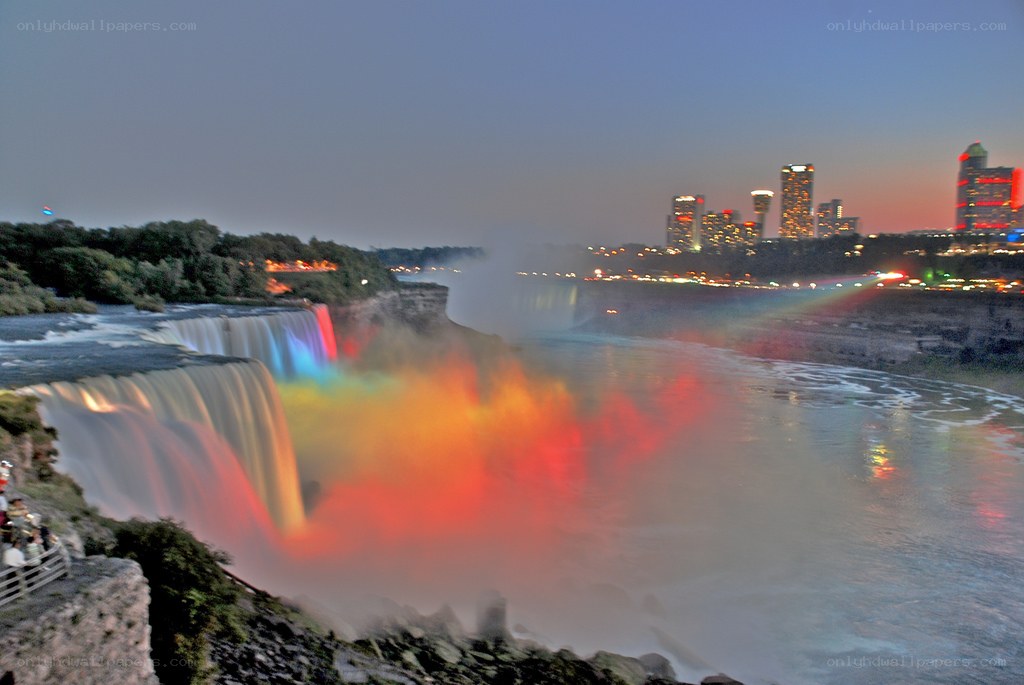 Niagara Falls at dusk with rainbow