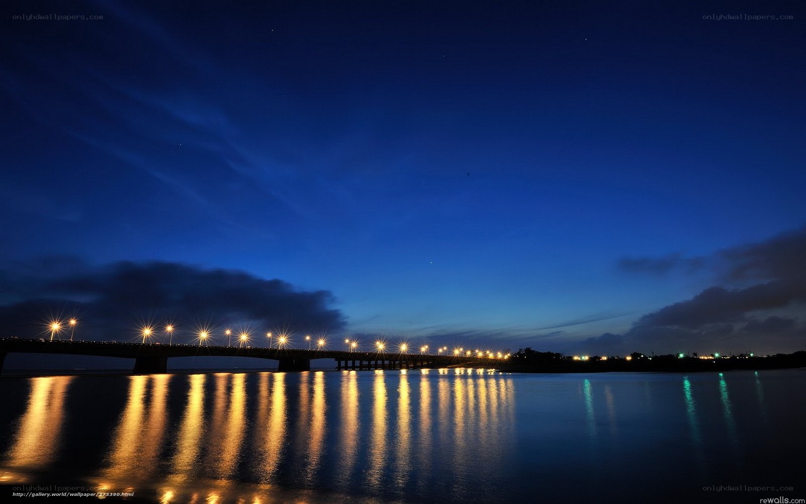 Night bridge over calm water