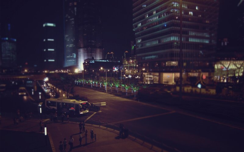 night cityscape with buses and pedestrians