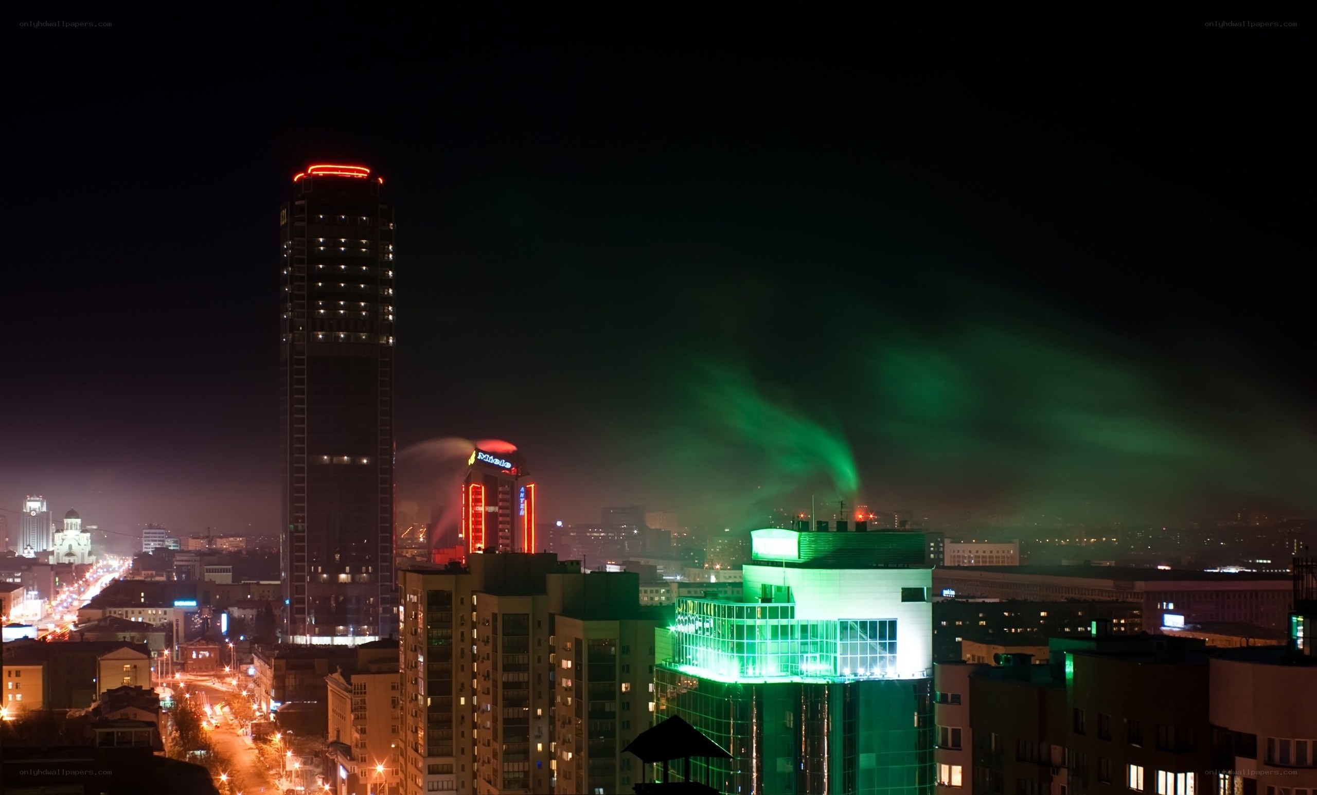 Night cityscape with green lights