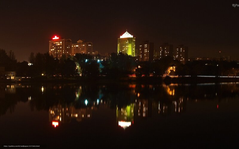 Night cityscape with lake reflection