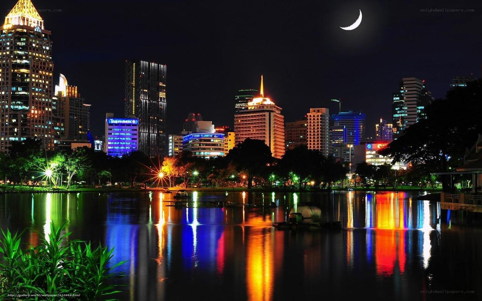night cityscape with moon and reflections