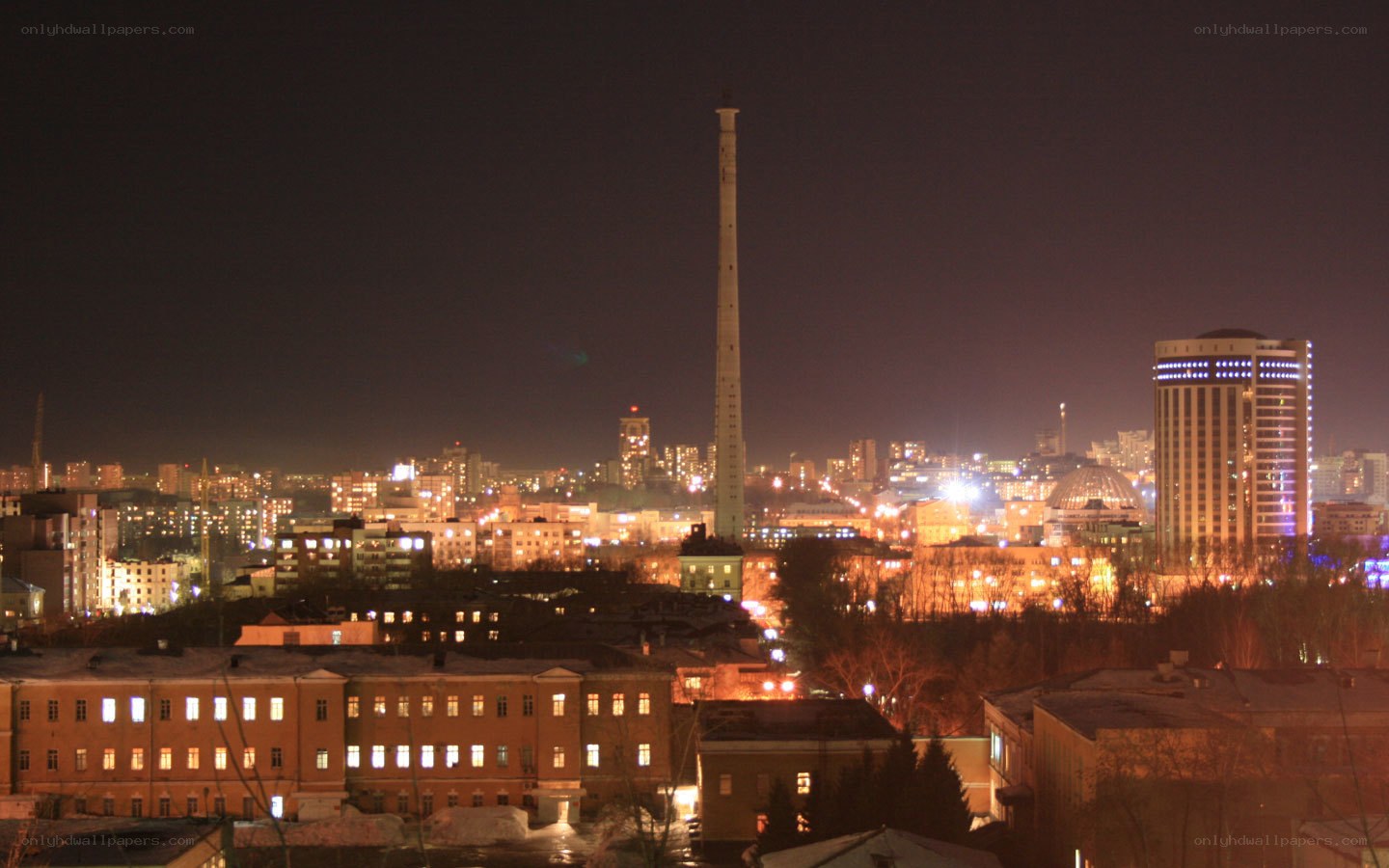 night cityscape with tall chimney
