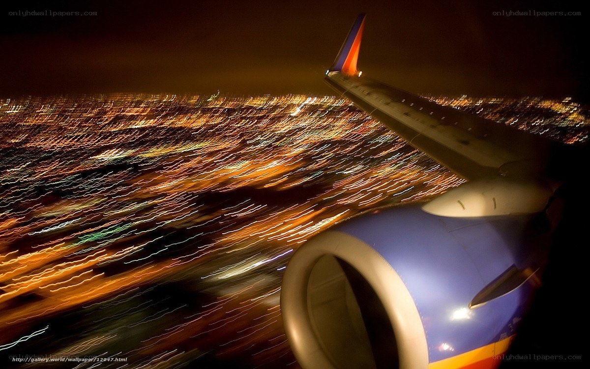 Night flight over city lights