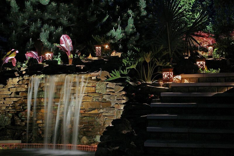 Night garden with waterfall and lanterns