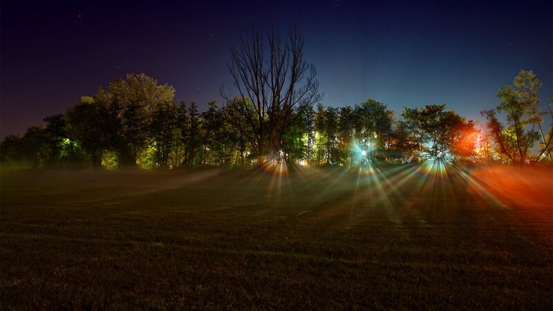Night lights in a misty field
