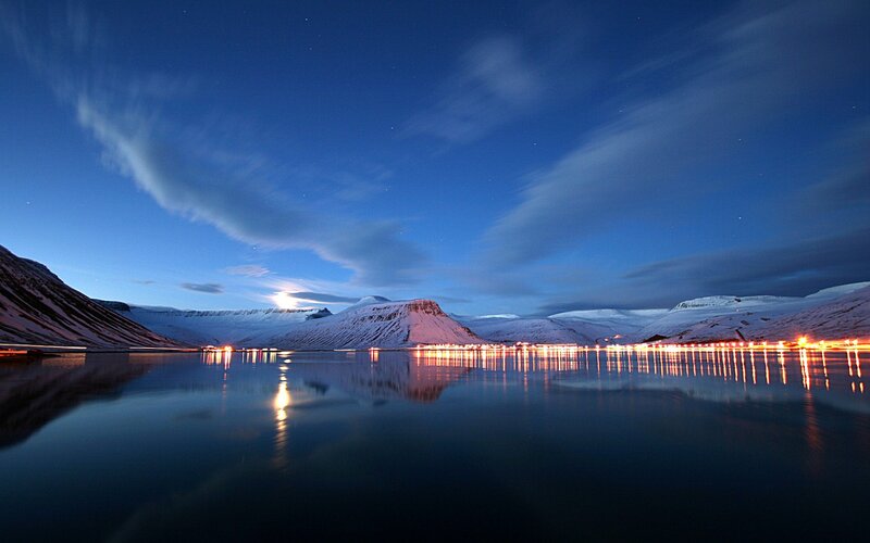 Night lights on a snowy fjord
