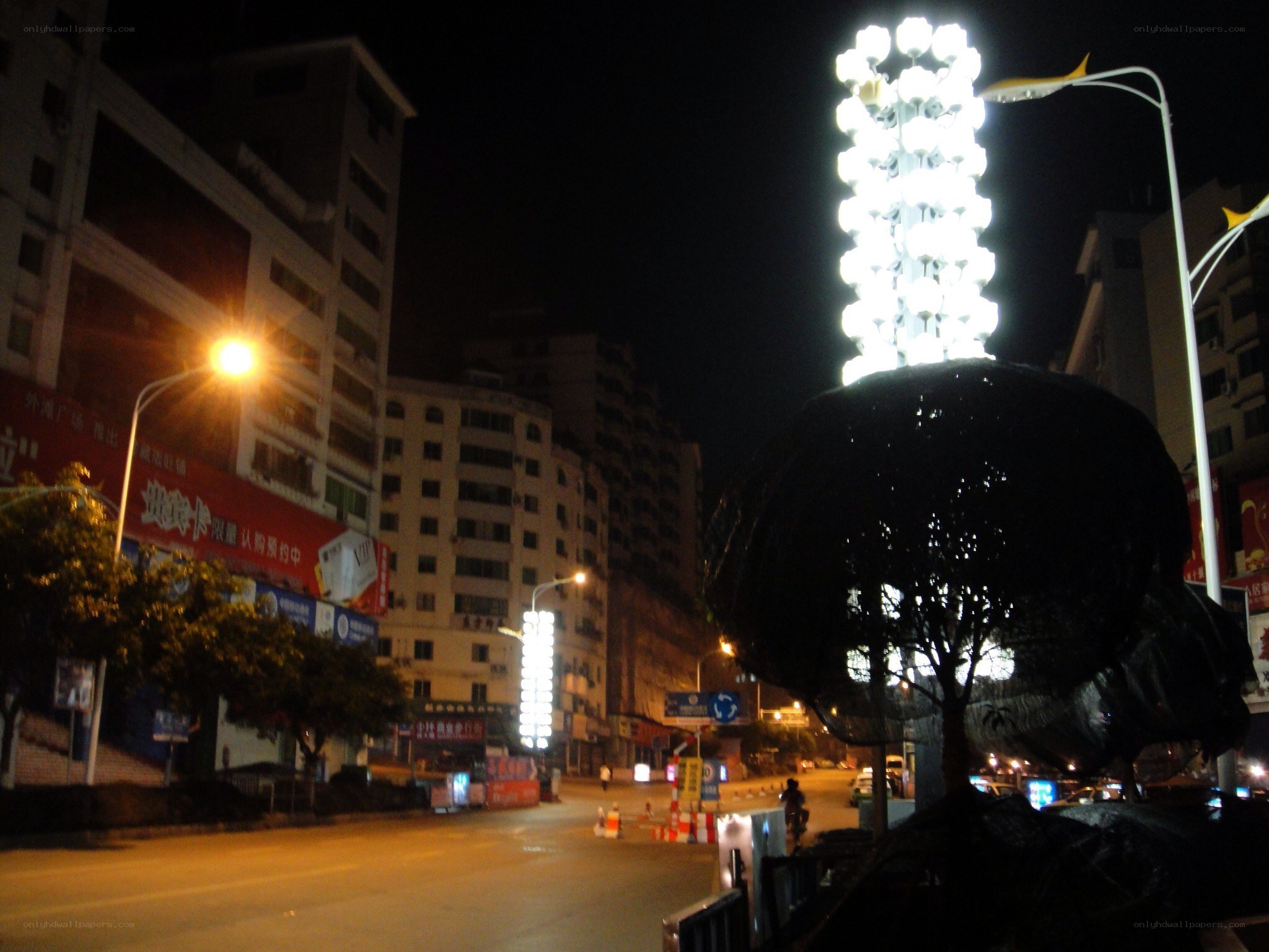 night scene with illuminated sculpture