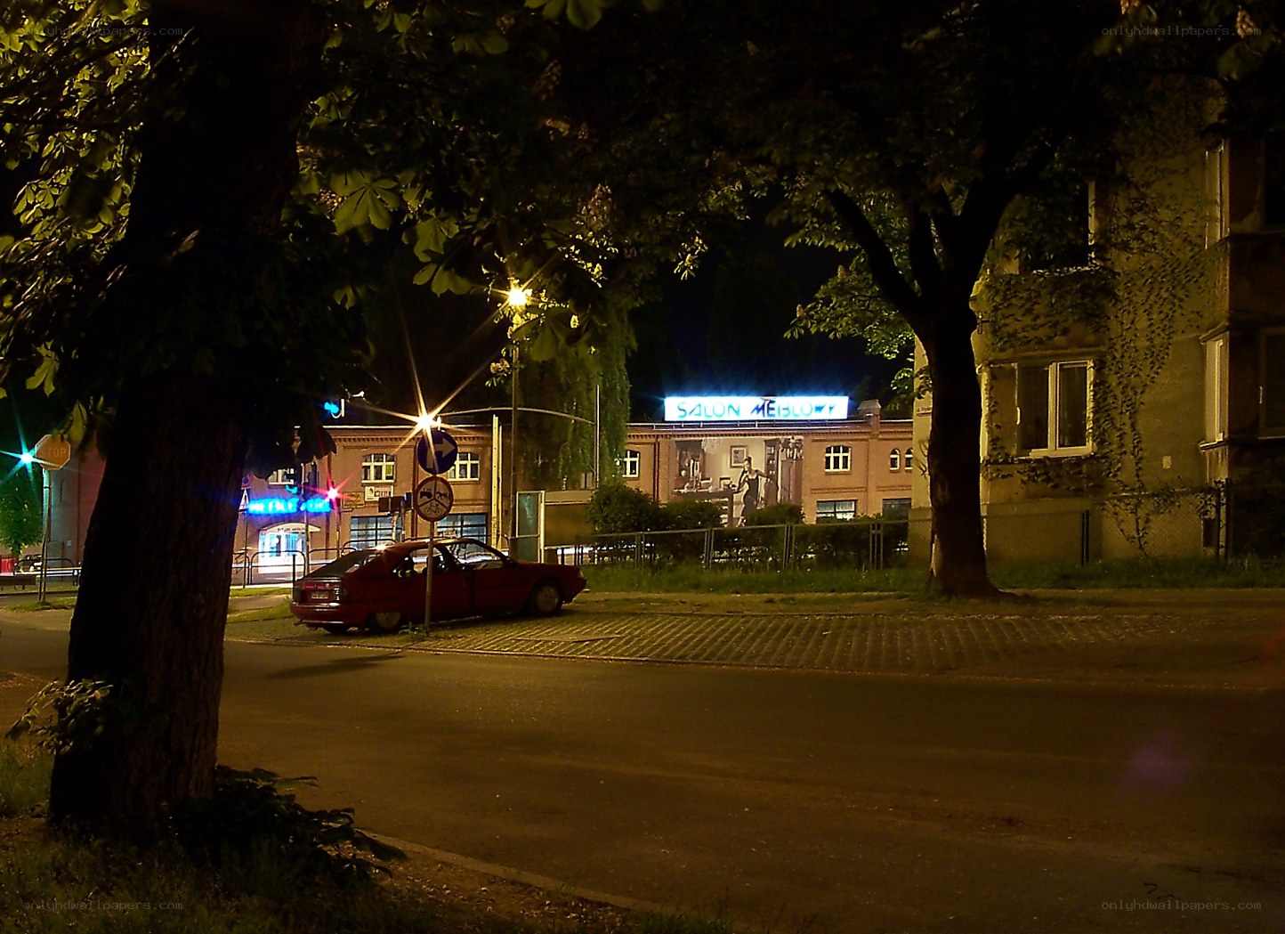 Night scene with red car and salon
