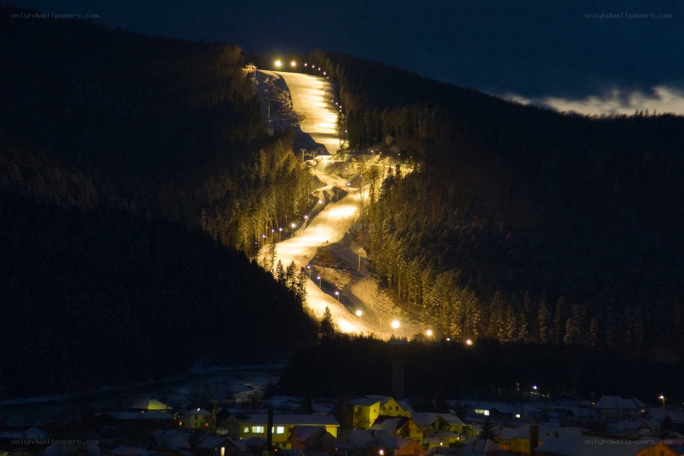 Night ski slope illuminated