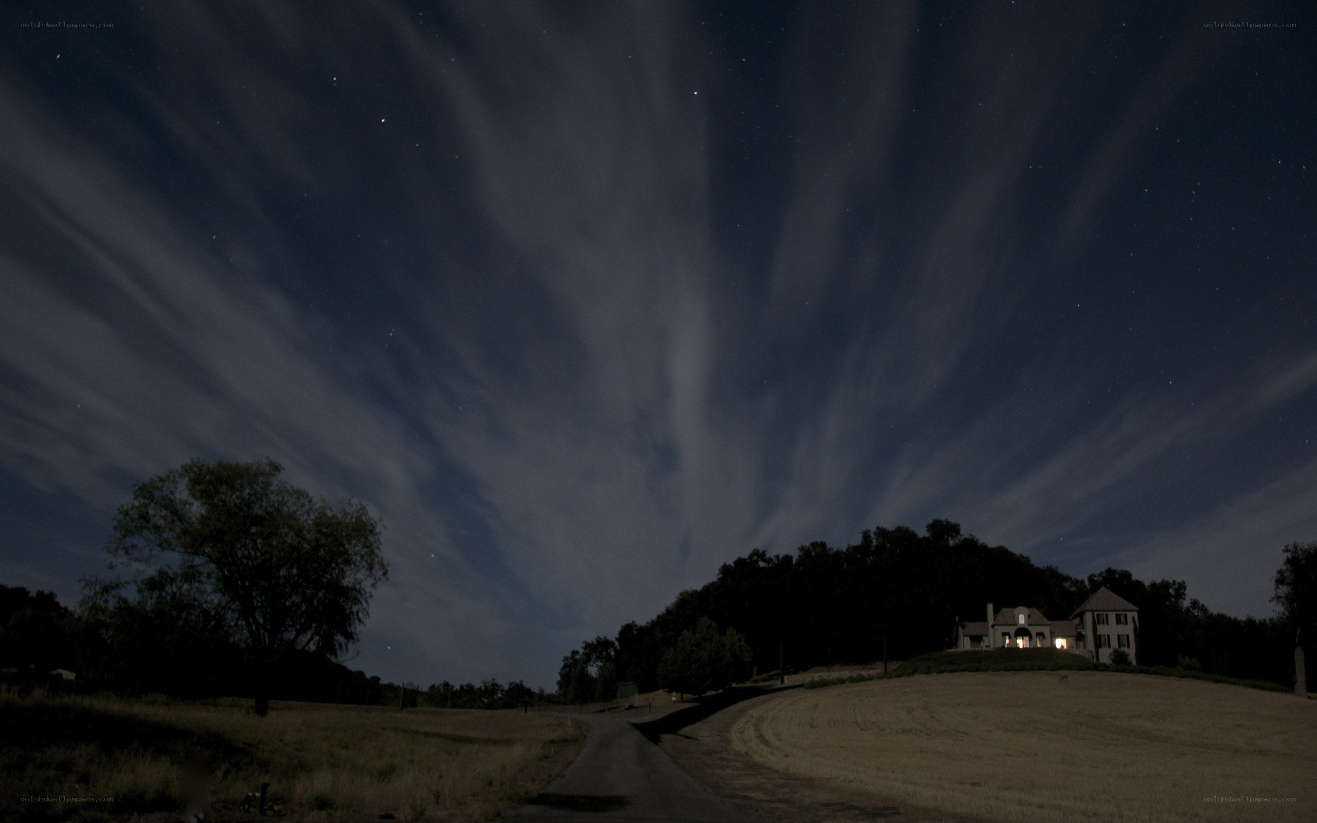 Night sky over a rural house