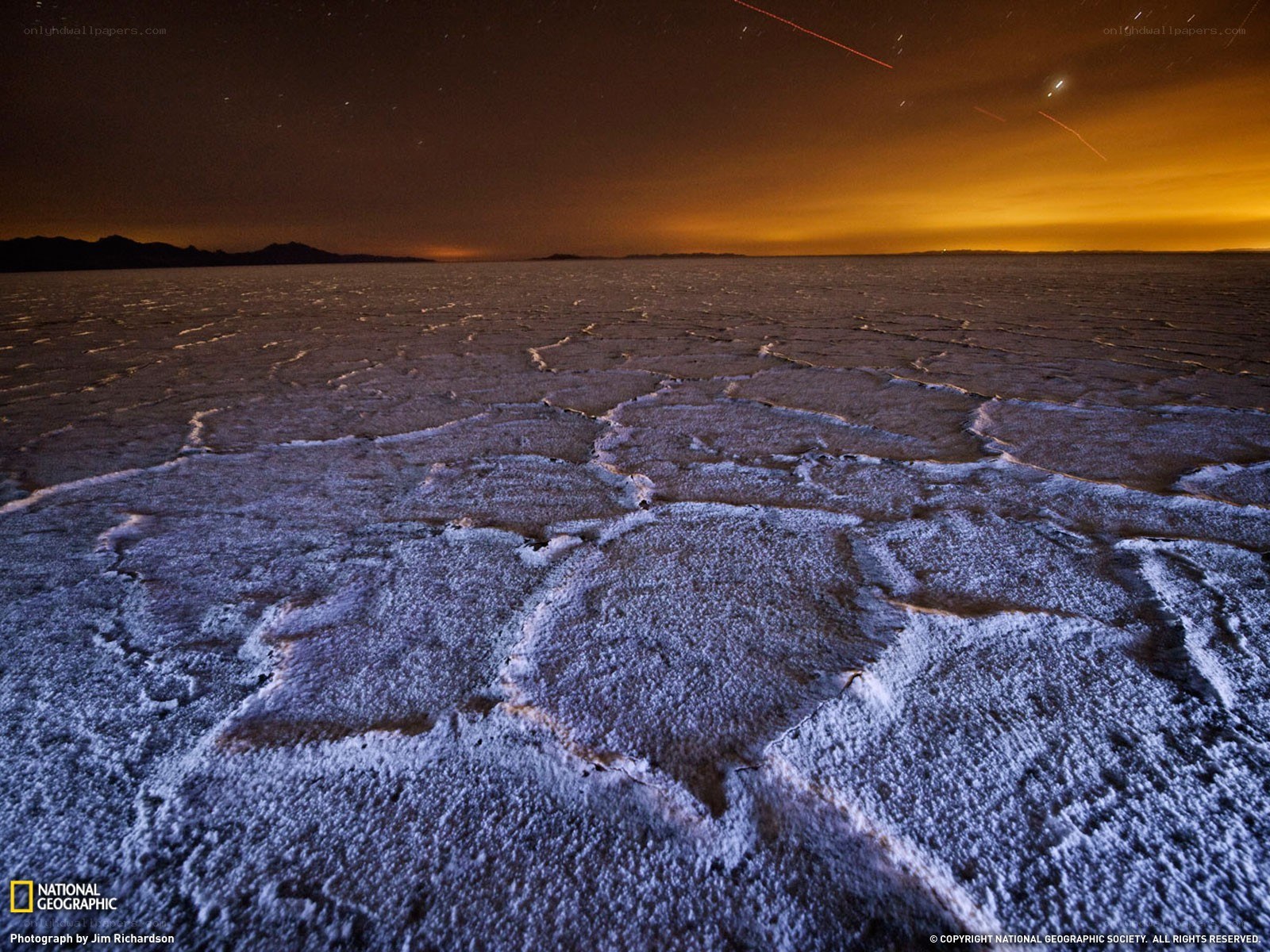 Night sky over cracked salt flats