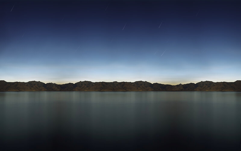 night sky over mountain lake