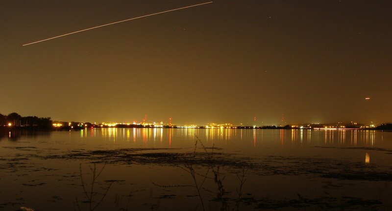 Night sky with airplane trail