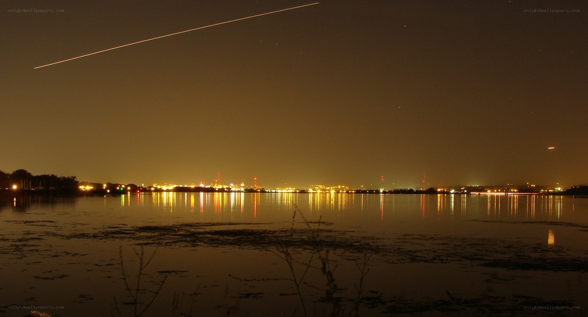 Night sky with airplane trail