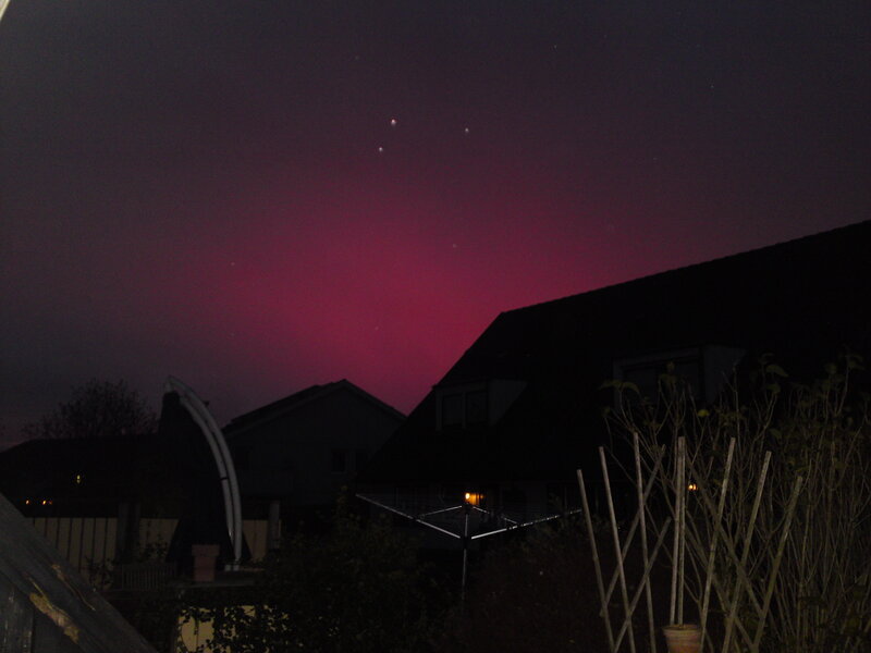 night sky with aurora and houses