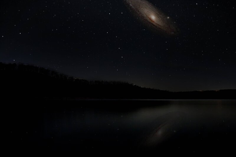 Night sky with galaxy over lake