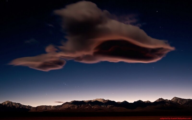Night sky with lenticular cloud