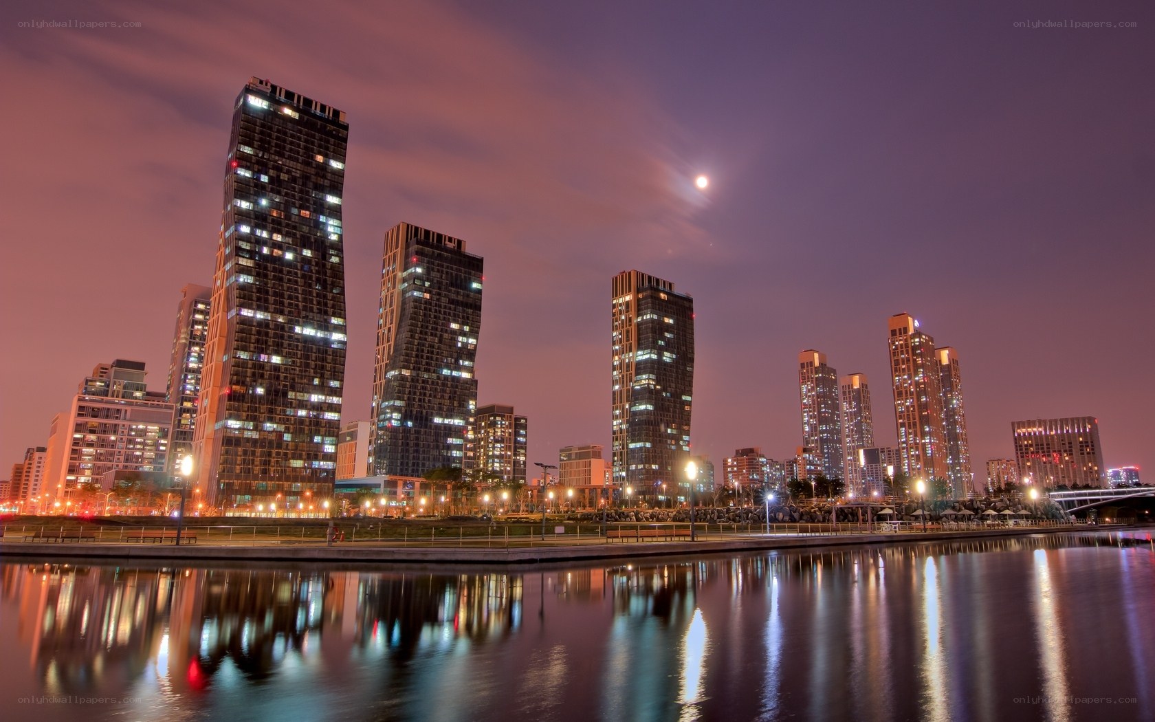 Night skyline with moon and reflections