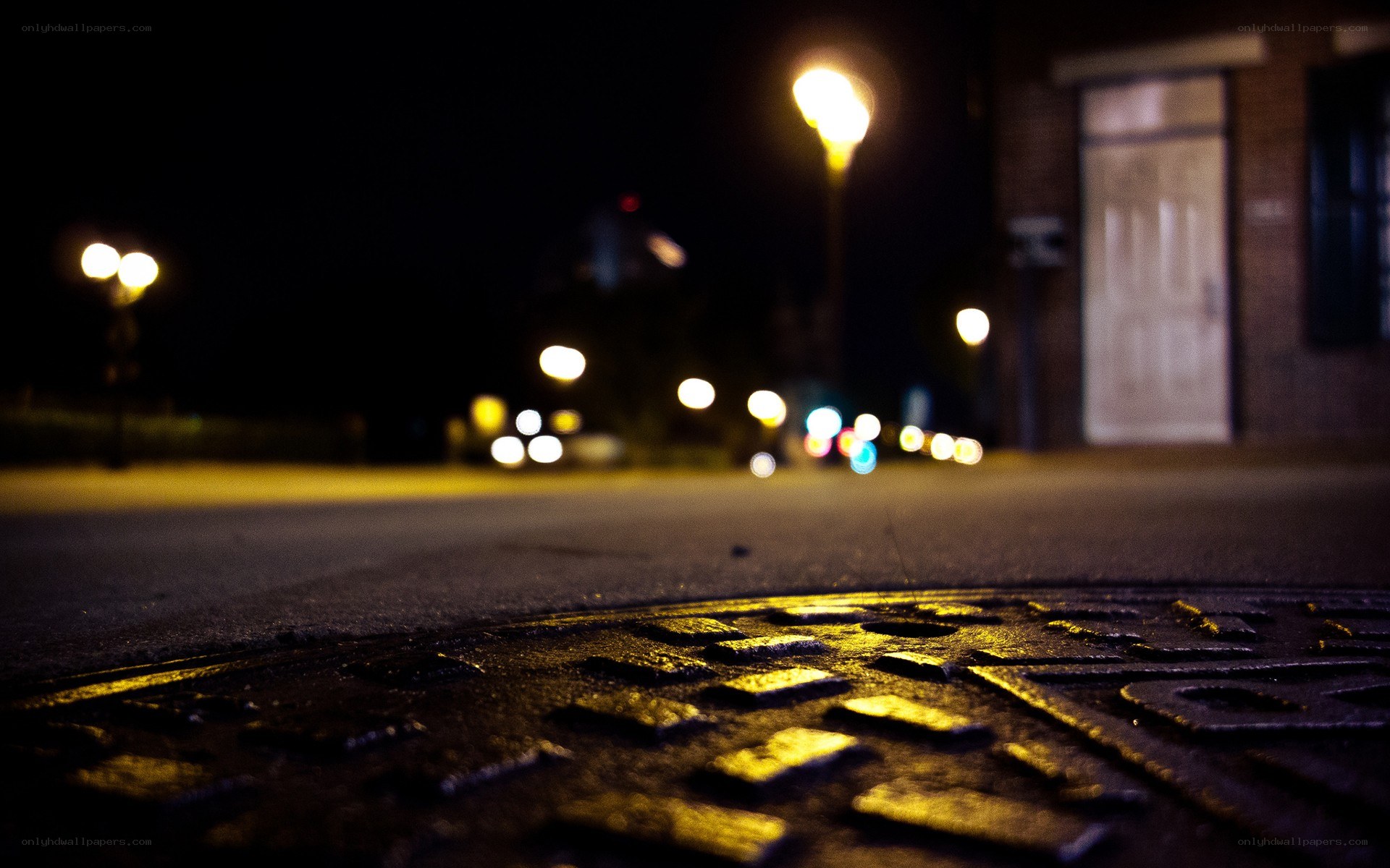 Night street with manhole cover