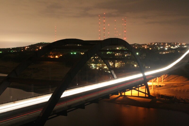 Night view of a bridge with light trails