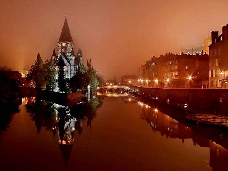 night view of a river and castle