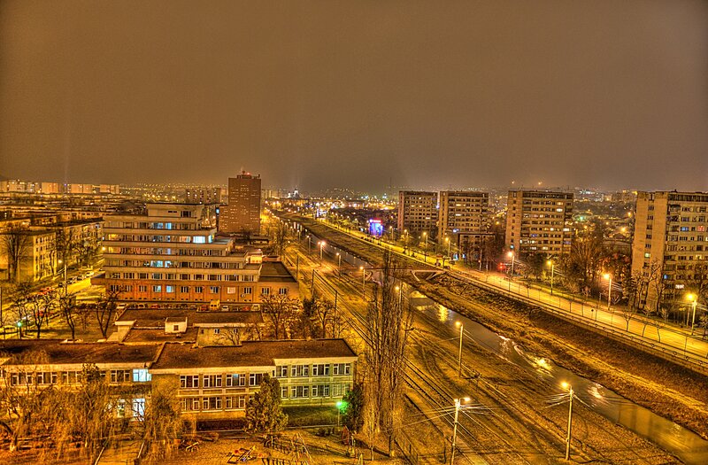 night view of city with train tracks