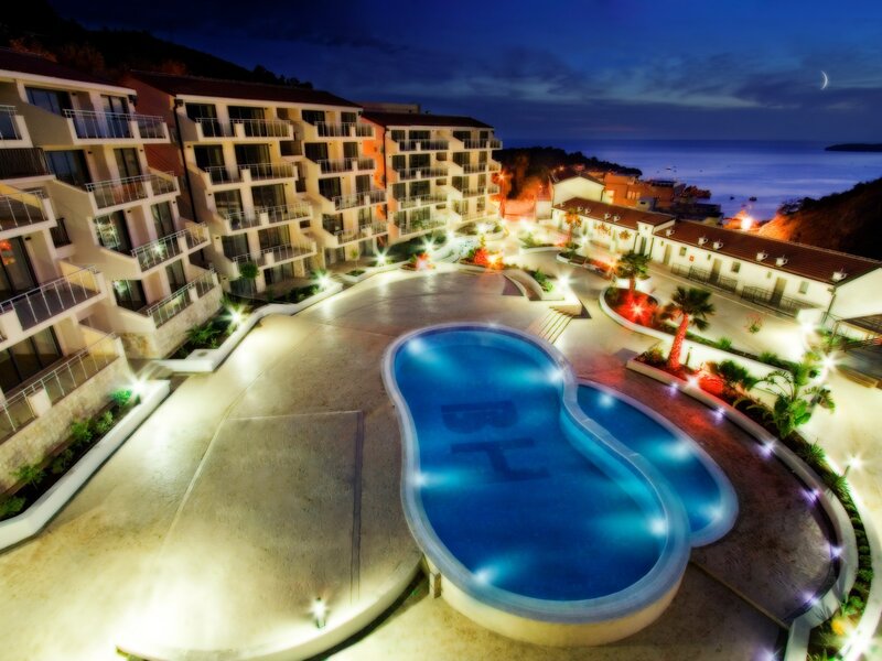 Night view of resort pool and buildings