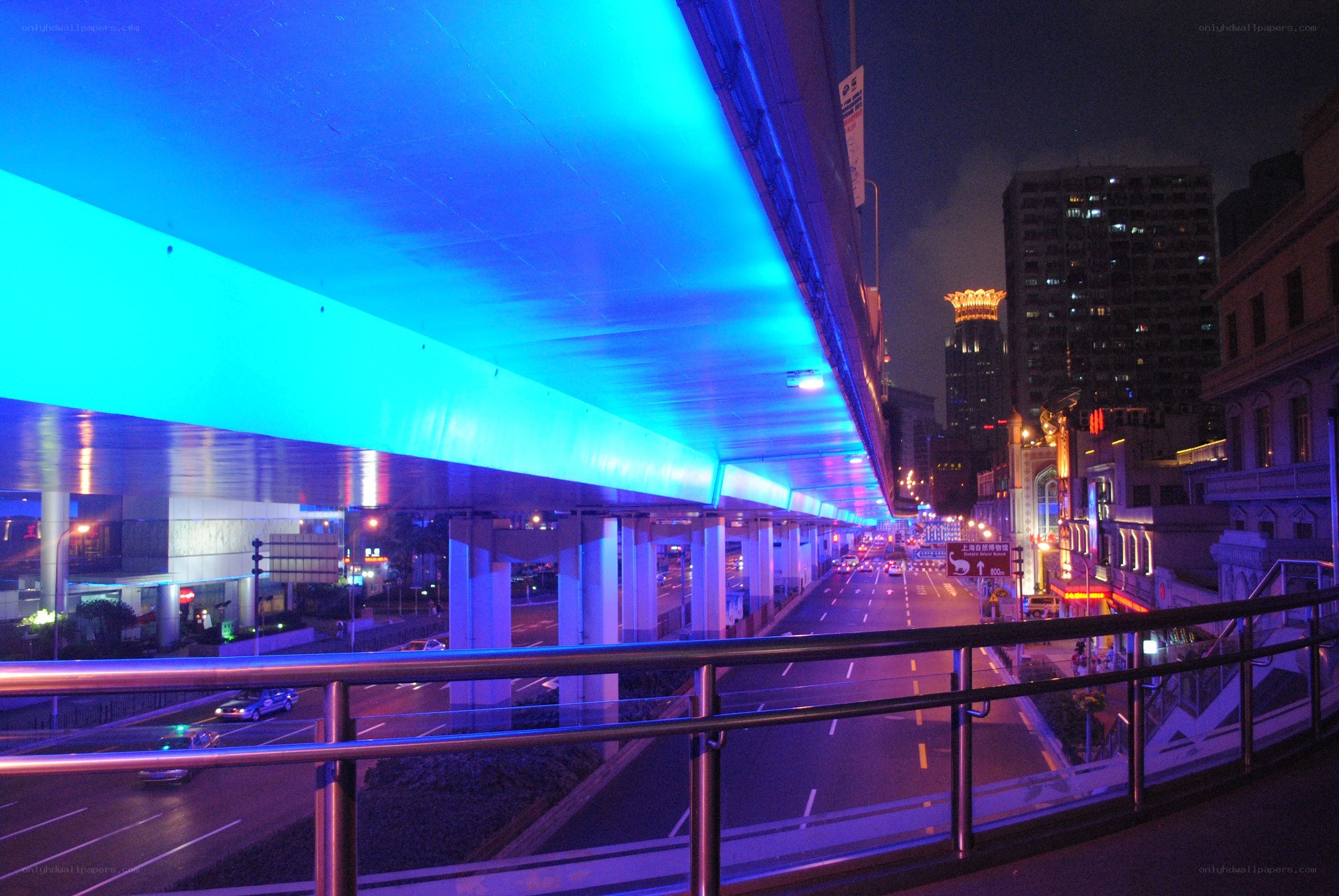 night view under a blue-lit bridge